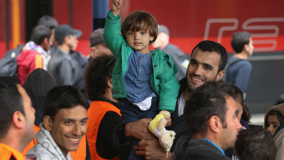 MUNICH, GERMANY - SEPTEMBER 06:  A child who had arrived with migrants on a train from Hungary gestures at Hauptbahnhof main railway station on September 6, 2015 in Munich, Germany. Over 10,000 migrants have traveled to Germany in the last 48 hours following an arduous ordeal in Hungary that resulted in thousands walking on foot and then being bussed by Hungarian authorities from Budapest to the Austrian-Hungarian border.  (Photo by Sean Gallup/Getty Images)