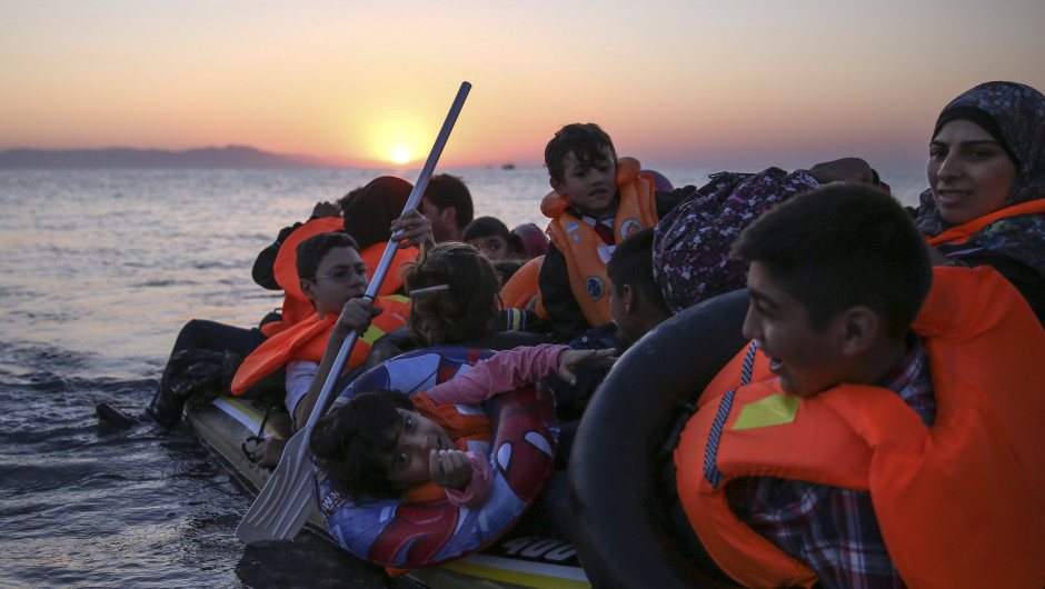 KOS, GREECE - AUGUST 28:  Migrant families from Syria arrive in an inflatable dinghy on the beach at sunrise on the island of Kos after crossing a three mile stretch of the Aegean Sea from Turkey on August 28, 2015 in Kos, Greece. Migrants from the Middle East and North Africa continue to flood into Europe at a rate that marks the largest migration since World War II.  (Photo by Dan Kitwood/Getty Images)