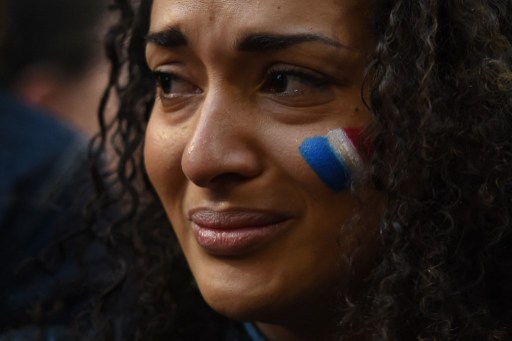 TOPSHOTSA woman weeps at a vigil held by the local French community in Sydney on November 14, 2015, as Australians express their solidarity with France following a spate of coordinated attacks that left 128 dead and 180 injured in Paris late on November 13. Both the Opera House and the Sydney Town Hall were bathed in the French colours and New South Wales state Premier Mike Baird said he had also asked for a French flag to fly over the city's famous harbour bridge. AFP PHOTO / William WEST