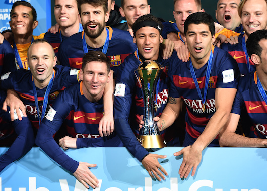 (Front L-R) Barcelona forward Andres Iniesta, forward Lionel Messi, forward Neymar and forward Luis Suarez celebrates with his teammates around the FIFA Club World Cup trophy on the podium of the Club World Cup football tournament final in Yokohama, suburban Tokyo on December 20, 2015.    AFP PHOTO / TOSHIFUMI KITAMURA / AFP / TOSHIFUMI KITAMURA