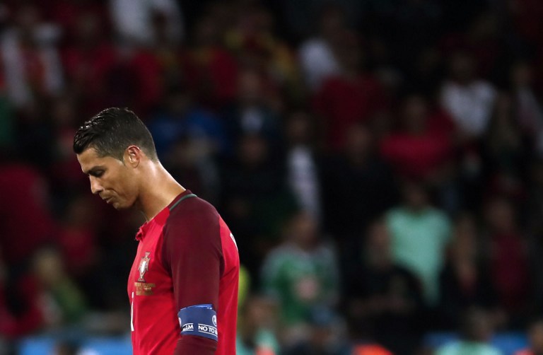 Portugal's forward Cristiano Ronaldo reacts after the Euro 2016 group F football match between Portugal and Iceland at the Geoffroy-Guichard stadium in Saint-Etienne on June 14, 2016. / AFP PHOTO / ODD ANDERSEN