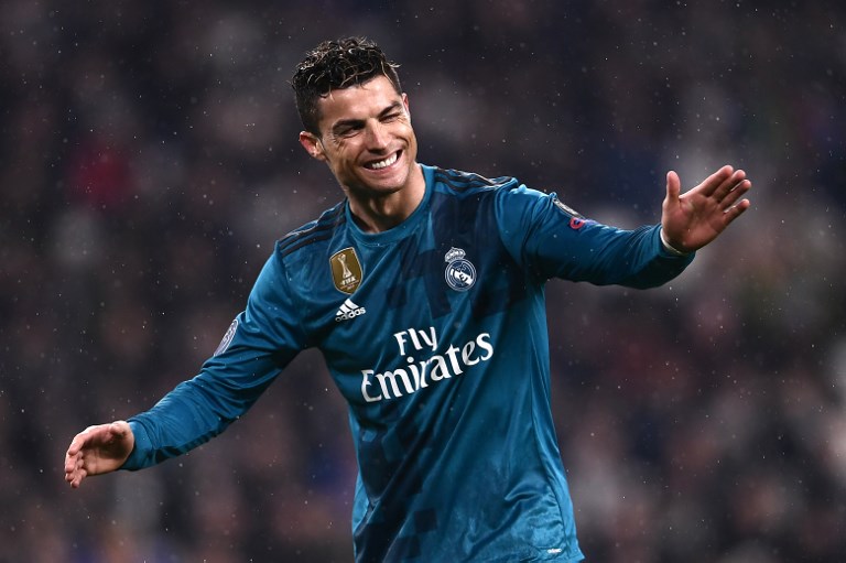 Real Madrid's Portuguese forward Cristiano Ronaldo celebrates after scoring a second goal during the UEFA Champions League quarter-final first leg football match between Juventus and Real Madrid at the Allianz Stadium in Turin on April 3, 2018. / AFP PHOTO / Marco BERTORELLO