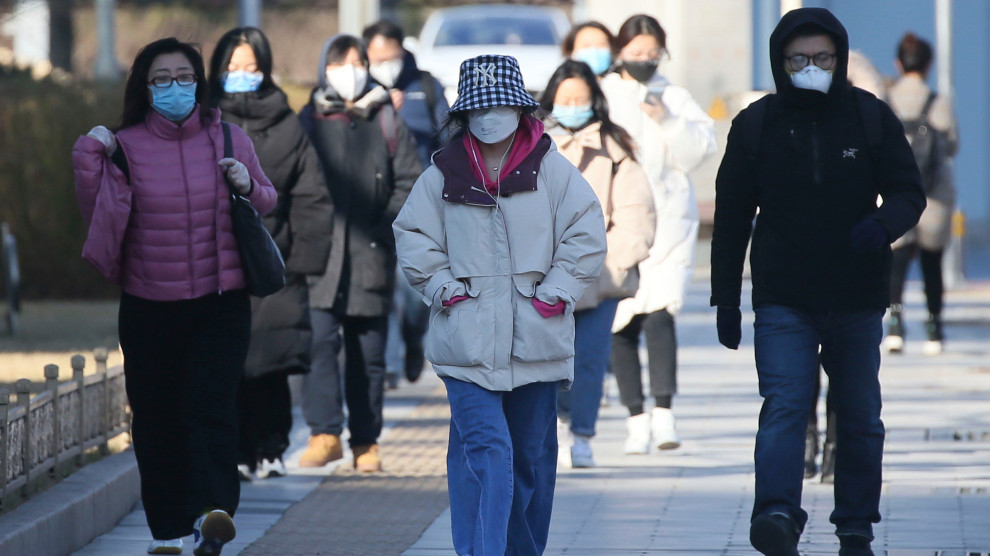 Mask-wearing people are seen at a street in Beijing, China on March 4, 2020, amid an outbreak of the new coronavirus COVID-19. The number of the new coronavirus COVID-19-hit patients has reached to 80,026 and the death toll has been confirmed 2,912so far as of March 2nd, in China. ( The Yomiuri Shimbun via AP Images )
