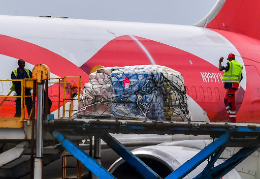 Workers load food and medicals aid for Venezuela from a US Boeing 767 aircraft shortly after landing at the Hato International Airport in Willemstad, Curacao in the Netherlands Antilles on February 21, 2019. (Photo by Luis ACOSTA / AFP)