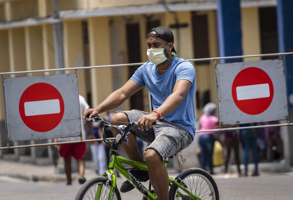 Un hombre con una mascarilla se pasea por La Habana