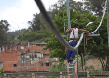 A man works on a pipe from a community-made water system that bring water that accumulated at a stalled tunnel construction project near El Avila mountain that borders the city of Caracas, Venezuela June 26, 2020. Picture taken June 26, 2020. REUTERS/Manaure Quintero