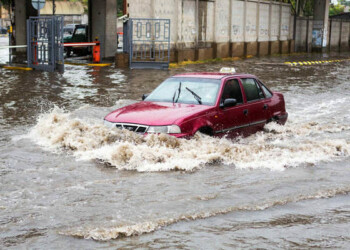 Odessa Ukraine - September 20 2016: Driving cars on a flooded road during flooding caused by torrential rains. Cars float on water flooded streets. The disaster in Odessa September 20 2016.