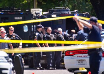 Baton Rouge Police Dept. officers gather at the scene on Conrad Drive in Baton Rouge, La., Sunday, April 26, 2020, where two Baton Rouge Police officers were shot, about a block off of Foster Drive.