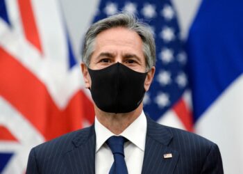 U.S. Secretary of State Antony Blinken wears a protective mask as he poses for a picture during a meeting at NATO's headquarters in Brussels on April 14, 2021. (Photo by JOHANNA GERON / POOL / AFP) (Photo by JOHANNA GERON/POOL/AFP via Getty Images)