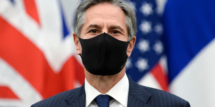 U.S. Secretary of State Antony Blinken wears a protective mask as he poses for a picture during a meeting at NATO's headquarters in Brussels on April 14, 2021. (Photo by JOHANNA GERON / POOL / AFP) (Photo by JOHANNA GERON/POOL/AFP via Getty Images)