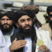 Taliban spokesman Zabihullah Mujahid (C) addresses a media conference at the airport in Kabul on August 31, 2021. - The Taliban joyously fired guns into the air and offered words of reconciliation on August 31, as they celebrated defeating the United States and returning to power after two decades of war that devastated Afghanistan. (Photo by WAKIL KOHSAR / AFP)