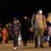Afghan people who were transported from Islamabad, walk after disembarking a plane, at the Torrejon military base in Spain on Monday, Oct. 11, 2021. (AP Photo/Manu Fernandez)