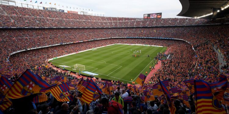 Fans cheer before the Spanish league football match between FC Barcelona and Real Sociedad at the Camp Nou stadium in Barcelona on May 20, 2018. / AFP PHOTO / LLUIS GENE