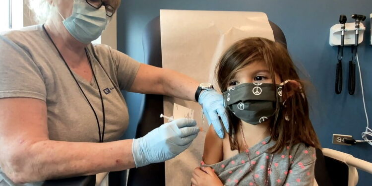 Bridgette Melo, 5, prepares for her inoculation of one of two reduced 10 ug doses of the Pfizer BioNtech COVID-19 vaccine during a trial at Duke University in Durham, North Carolina September 28, 2021 in a still image from video. Video taken September 28, 2021. Shawn Rocco/Duke University/Handout via REUTERS NO RESALES. NO ARCHIVES. THIS IMAGE HAS BEEN SUPPLIED BY A THIRD PARTY.