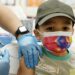 Oliver Estrada, 5, receives the first dose of the Pfizer COVID-19 vaccine at an Adelante Healthcare community vaccine clinic at Joseph Zito Elementary School, Saturday, Nov. 6, 2021, in Phoenix. This was the first time children aged 5 to 11 across the United States had the opportunity to get immunized against COVID-19. (AP Photo/Ross D. Franklin)