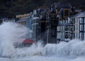 Waves caused by Storm Eunice break over Aberystwyth promenade in Aberystwyth, Wales, Britain, February 18, 2022. REUTERS/Carl Recine