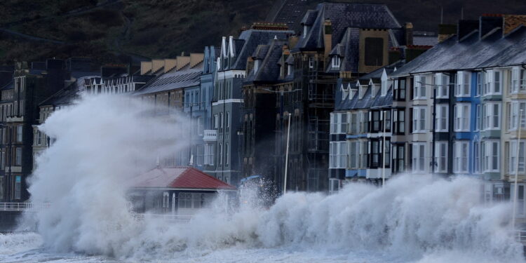 Waves caused by Storm Eunice break over Aberystwyth promenade in Aberystwyth, Wales, Britain, February 18, 2022. REUTERS/Carl Recine