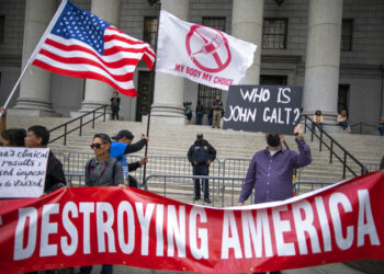 Police watch as people and teachers hold a protest against COVID vaccine mandates outside the Manhattan Federal Court Tuesday, Oct. 12, 2021, in New York. (AP Photo/Eduardo Munoz Alvarez)