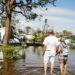 People walk on a flooded street at a trailer park following Hurricane Ian in Fort Myers, Florida, US, on Thursday, Sept. 29, 2022. Ian, now a hurricane again, is threatening to carve a new path of destruction through South Carolina Friday when it roars ashore north of Charleston. Photographer: Eva Marie Uzcategui/Bloomberg