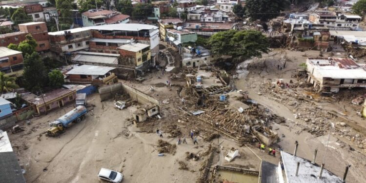 Aerial view of the zone affected by a landslide during heavy rains in Las Tejerias, Aragua state, Venezuela, on October 10, 2022. - A landslide in central Venezuela left at least 22 people dead and more than 50 missing after heavy rains caused a river to overflow, Vice President Delcy Rodriguez said Sunday. (Photo by Yuri CORTEZ / AFP)