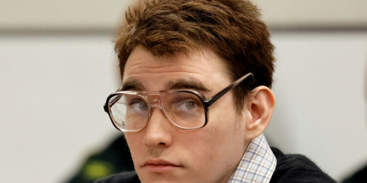 Marjory Stoneman Douglas High School shooter Nikolas Cruz looks up as Assistant Public Defender Melisa McNeill gives the defense's opening statement during the penalty phase of his trial at the Broward County Courthouse in Fort Lauderdale, Florida, U.S., August 22, 2022.   Amy Beth Bennett/South Florida Sun Sentinel/Pool via REUTERS