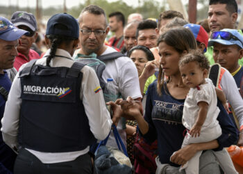 PARAGUACHON, COLOMBIA - JUNE 08: Venezuelans and Colombian returnees line up to enter to Colombia from Venezuela near the border between Colombia and Venezuela on June 8, 2019 in Paraguachon, Colombia. Today United Nations High Commissioner for Refugees (UNCHR) Special Envoy Angelina Jolie and Deputy High Commissioner Kelly Clements will visit the UNHCR refugee camp of Maicao, located 8km west of the border between Colombia and Venezuela, a key point for migrants to cross. UN and International Organization for Migration (IOM) announced yesterday that 4 million Venezuelans have left their country since 2015 due to the social, political and economic crisis, which means they are the single largest population groups displaced from their country globally. The camp in Maicao has 60 tents which can accommodate up to 350 people. Due to high demand, UNHCR is considering an expansion to give shelter to 1,400 people. Colombia is the top host of Venezuelan migrants and refugees, accounting 1.3 million. (Photo by Guillermo Legaria/Getty Images)