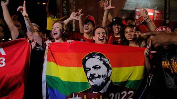 Supporters of Brazilian former President (2003-2010) and candidate for the leftist Workers Party (PT) Luiz Inacio Lula da Silva celebrate while watching the vote count of the presidential run-off election at the Paulista avenue in Sao Paulo, Brazil, on October 30, 2022. (Photo by CAIO GUATELLI / AFP) (Photo by CAIO GUATELLI/AFP via Getty Images)