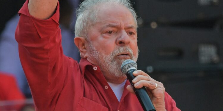 Brazilian presidential pre-candidate for the leftist Workers Party (PT), former president (2003-2010) Luiz Inacio Lula da Silva, raises his clenched fist as he speaks to supporters during a campaign rally in Diadema, Sao Paulo state, Brazil, on July 9 2022. (Photo by NELSON ALMEIDA / AFP)