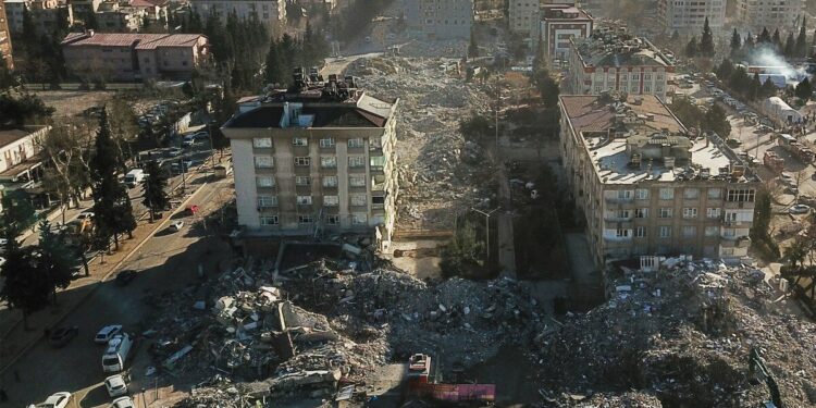 This aerial view shows collapsed buildings during the ongoing rescue operation in Kahramanmaras, the epicentre of the first 7.8-magnitude earthquake seven days ago, in southeastern Turkey, on February 13, 2023. - The death toll from a catastrophic earthquake that hit Turkey and Syria climbed above 35,000 on February 13, 2023, with search and rescue teams starting to wind down their work. (Photo by OZAN KOSE / AFP)