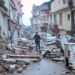 A man runs along a street strewn with debris, in Hatay,  the day after a 7.8-magnitude earthquake struck the country's southeast on February 7, 2023. - Rescuers in Turkey and Syria braved frigid weather, aftershocks and collapsing buildings, as they dug for survivors buried by an earthquake that killed more than 5,000 people. Up to 23 million people could be affected by the massive earthquake that has killed thousands in Turkey and Syria, the WHO warned on Tuesday, promising long-term assistance. (Photo by BULENT KILIC / AFP)