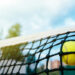 Close-up photo of tennis ball hitting to net. Sport concept.